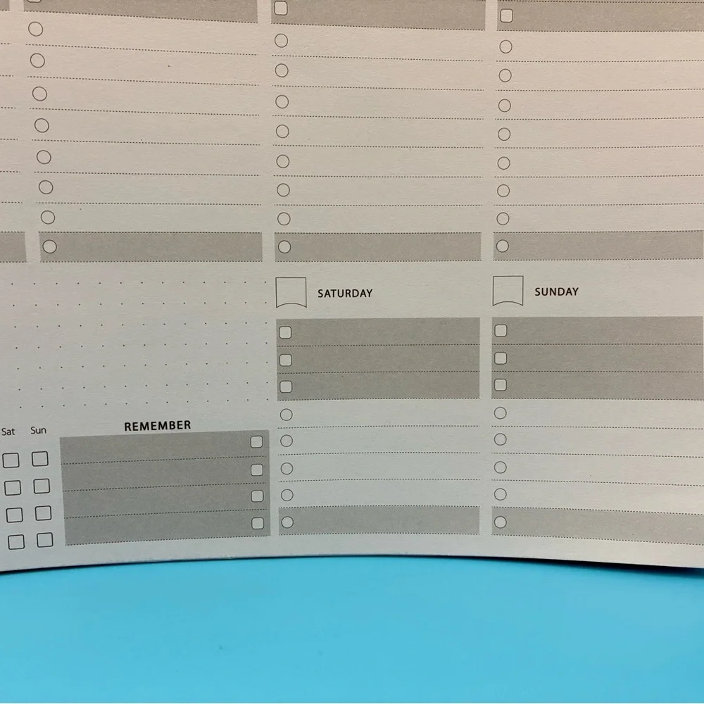 Zerone Productivity weekly planner featuring a gold spiral binding.